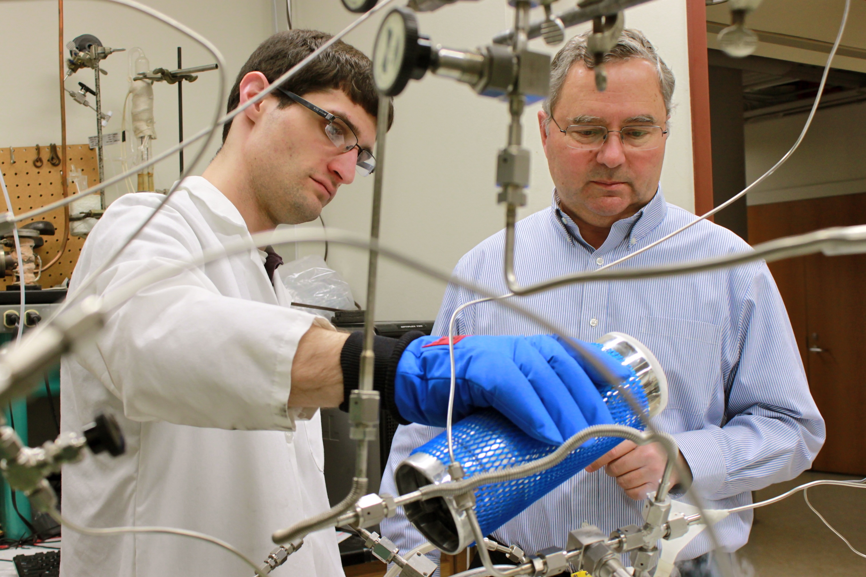 An image of scientists studying a tube.