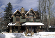 Photo of a ski lodge with snow surrounding it.