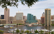 A photo of a city skyline with a river in the foreground.