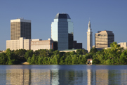A photo of a city skyline with a river in the foreground.