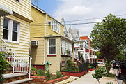 Photo of a block of residential homes in what appears to be an urban area.