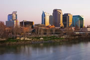 Photo of the Sacramento skyline in the daytime, with many tall buildings in a downtown cluster.