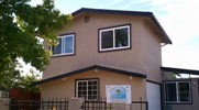 Photo of a home focusing on its upper level, showing its windows facing the camera.