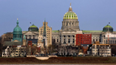 A photo of a city skyline that includes a capitol building.