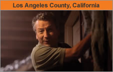 Photo of a man standing next to the inside of a house and the insulation on the wall. The headline over the photo reads 'Los Angeles County, California.'
