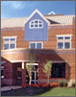 Close-up photo of the exterior of a two-story, brick building.