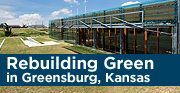 Photo of a long glass building with grass in front blue skies in the background. The text reads: Rebuilding Green in Greensburg, Kansas