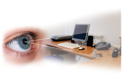 A graphic image with an eye on the left side of the image.  The pupil of the eye is small.  On the right side of the image is a photo of a desktop with a phone and computer monitor on top.  There are lines drawn from the pupil of the eye in a V-shape with the opening of the V centered on the objects on the desktop.  The graphic is demonstrating that the items on the desk appear brighter and crisper even with lower levels of light if the lighting is spectrally enhanced.