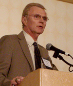 Photo of a man standing at a podium.