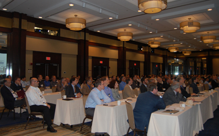 Photo of a large group of people seated at long tables.