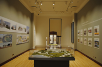 Photo of a museum gallery with a display case at center and LED track lighting overhead.
