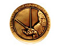 Photo of a gold circular medallion with illegible writing around the top edge and an image of a man holding something in his hand.