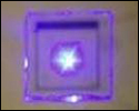 Photo of a bright purple square with a purple frame containing a bright white light in the center.