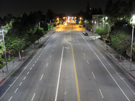 photo of an urban roadway at night lined with LED streetlights.