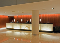 Photo of a reception desk in a hotel lobby featuring LED lighting.