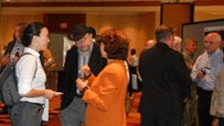 Photo of groups of people talking in a hotel foyer.