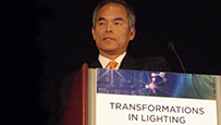 Photo of a man standing behind a podium.