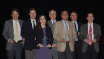 Photo of seven people standing and holding awards.