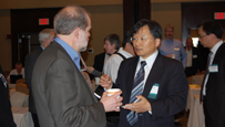 Photo of two men talking.