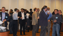 Photo of a large number of people talking in groups.