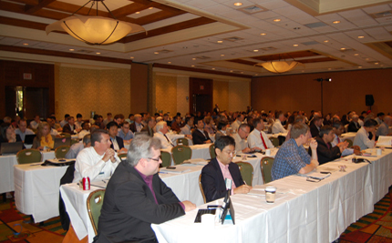 Photo of workshop attendees seated at long tables.