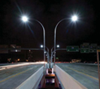 Photo of a road at night with an LED streetlight.