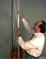Photo of channel bars being attached to an exhibit display frame.