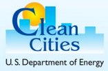 clean cities logo, a sun setting over a city skyline