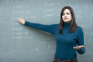A teacher at a blackboard filled with equations making a point to a classroom.