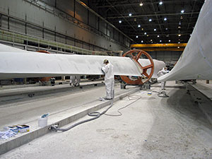 Photo of wind turbine blades being manufactured.