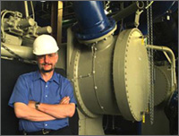 Photo of Project Coordinator Steve Krstulovich with Fermilab's new 1400-ton, high-efficiency chiller.