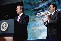 Photo of President George Bush at podium; Secretary of Energy Spencer Abraham clapping.
