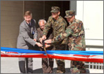 Photo of group of men cutting a ribbon at the new co-generation plant at Twentynine Palms Marine Corps Base, CA.
