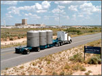 Photo of truck carrying three containers.