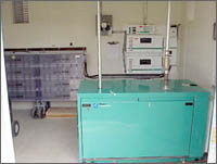 Photo of the propane-fueled generator, battery bank, and inverters inside the generation/distribution building