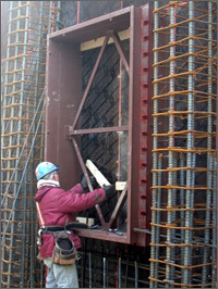 A photo of a contractor installing a blast-resistant window frame in the outer facade of the Pentagon's E-ring.