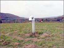 Photo of  a landfill site with closeup of alternative methane fuel capture