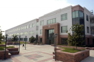 Picture of a large new Federal building with large windows along the exterior.