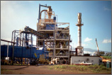 Photo of an industrial complex with large piping running in and out of facilities.
