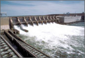 Photo of water flowing from several openings in a hydropower dam.