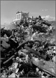 Black and white photo of a bulldozer pushing a large mound of trash in a landfill.