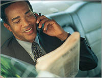 Photo of a man talking on a cell phone in a car.