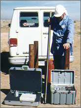 Photo of researchers holding a pressure and temperature memory tool.