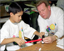 Teacher helping student in the classroom.