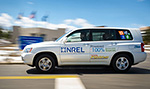 Photo of a white Toyota FCHV-adv sport utility vehicle emblazoned with an NREL logo.