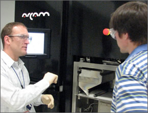 Instructor facing a student who is testing MDF equipment