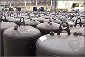 Photo of several rows of black hybrid water heater tanks.