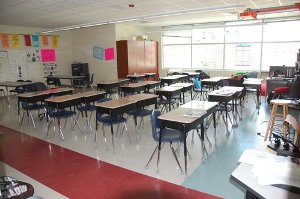 Photo of the inside of a classroom with lights off.
