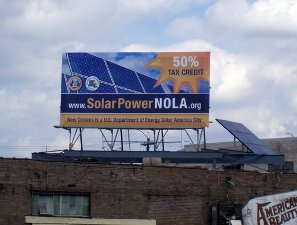 Photo of a billboard that reads www.solarpowernola.org.
