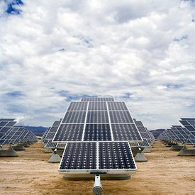 Photo of a SunPower T20 solar photovoltaic tracker at Nellis Air Force Base in Nevada framed by a cloudy blue sky. The power plant produces 14 megawatts of power and offsets 25% of the base's electricity needs. 